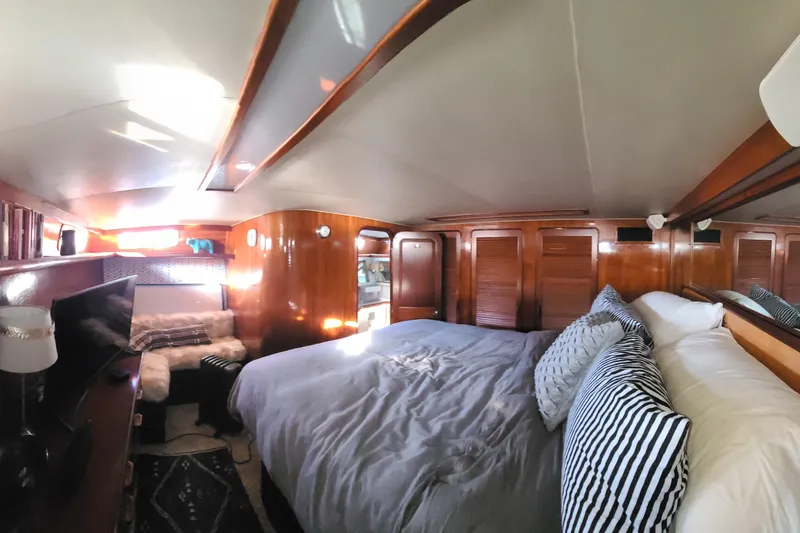 Slide: The Image of Luxurious bedroom interior of 1986 Gulfstar 49 Motor Yacht with cozy bedding and wooden finishes. - 17