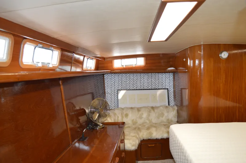 Slide: The Image of Interior cabin of 1986 Gulfstar 49 Motor Yacht with wood paneling and cozy seating. - 18