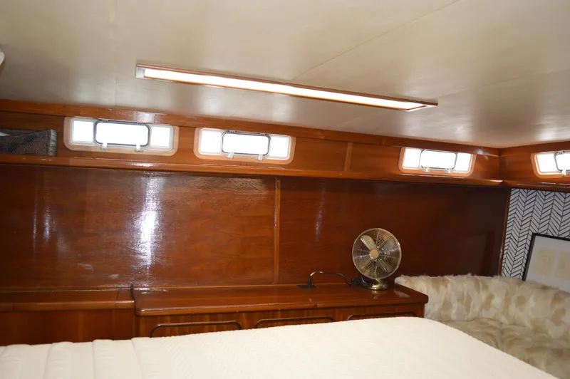 Slide: The Image of Interior cabin of 1986 Gulfstar 49 Motor Yacht with wooden paneling and small windows. - 19