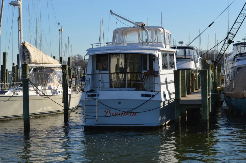 Slide: The Image of 1986 Gulfstar 49 Motor Yacht docked at marina. - 2
