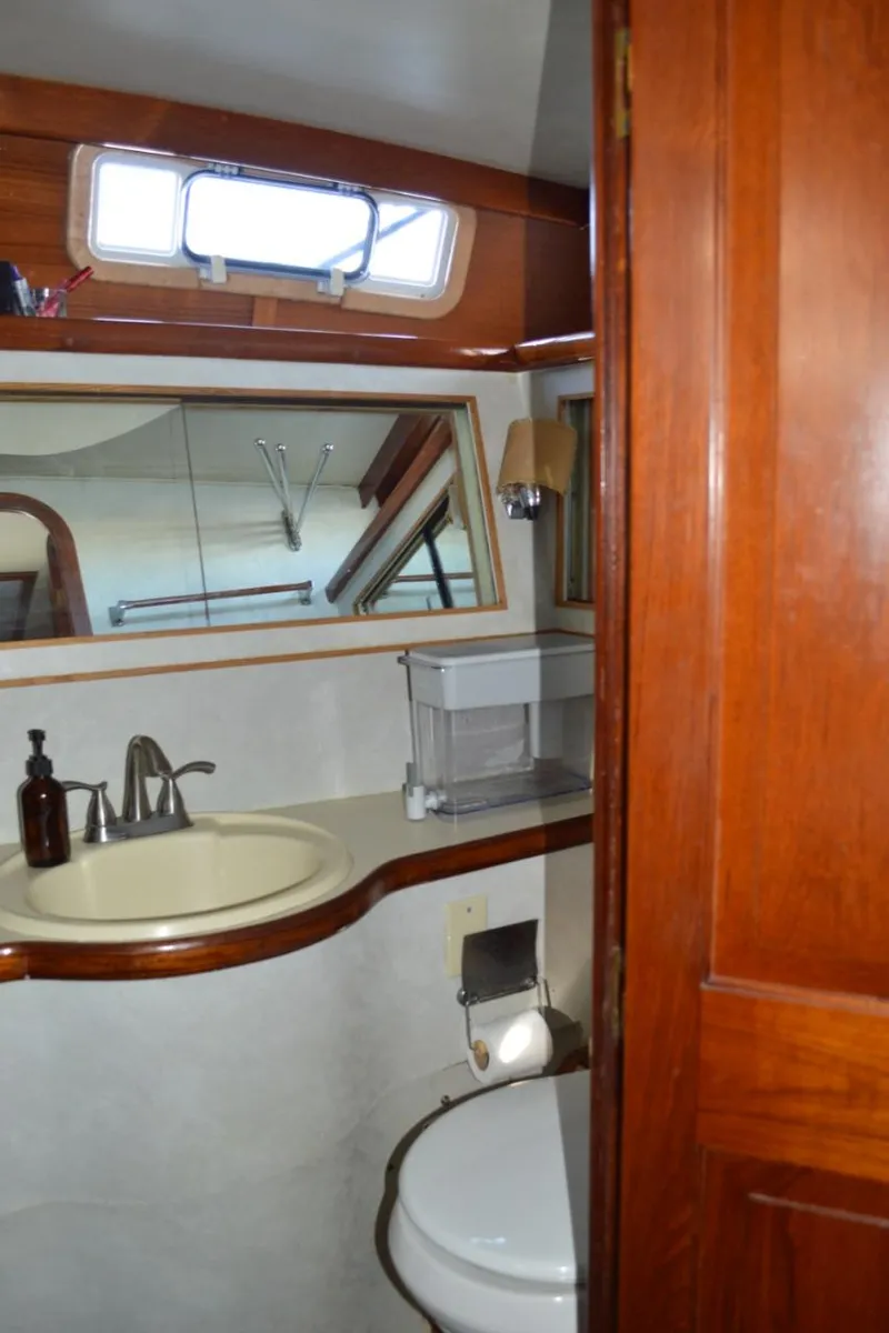 Slide: The Image of 1986 Gulfstar 49 Motor Yacht bathroom with sink, mirror, and toilet. - 26