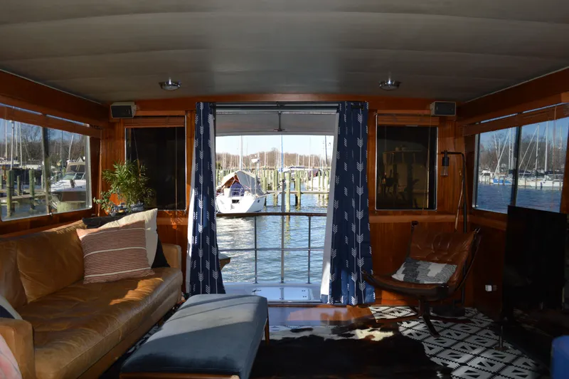 Slide: The Image of Interior of 1986 Gulfstar 49 Motor Yacht with cozy seating and marina view. - 4