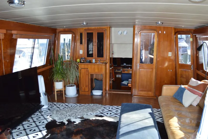Slide: The Image of Interior of a 1986 Gulfstar 49 Motor Yacht with wooden furnishings and modern decor. - 5