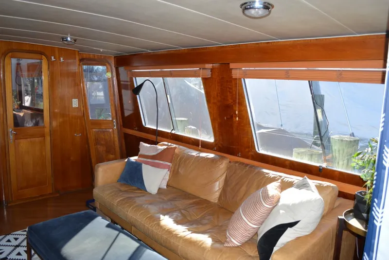 Slide: The Image of Interior of 1986 Gulfstar 49 Motor Yacht with leather sofa and large windows. - 6