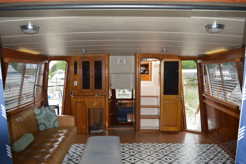 Slide: The Image of Interior of 1986 Gulfstar 49 Motor Yacht with wooden furnishings and large windows. - 7