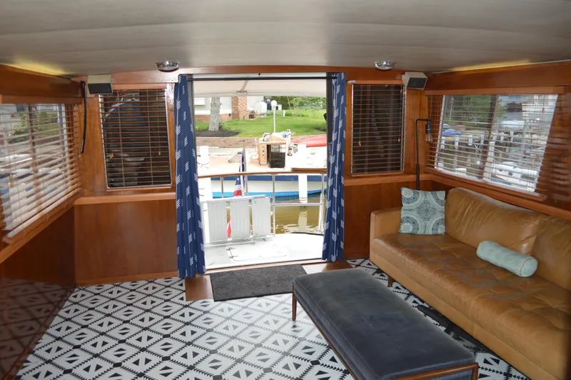 Slide: The Image of Interior of 1986 Gulfstar 49 Motor Yacht with leather sofa and patterned rug. - 8