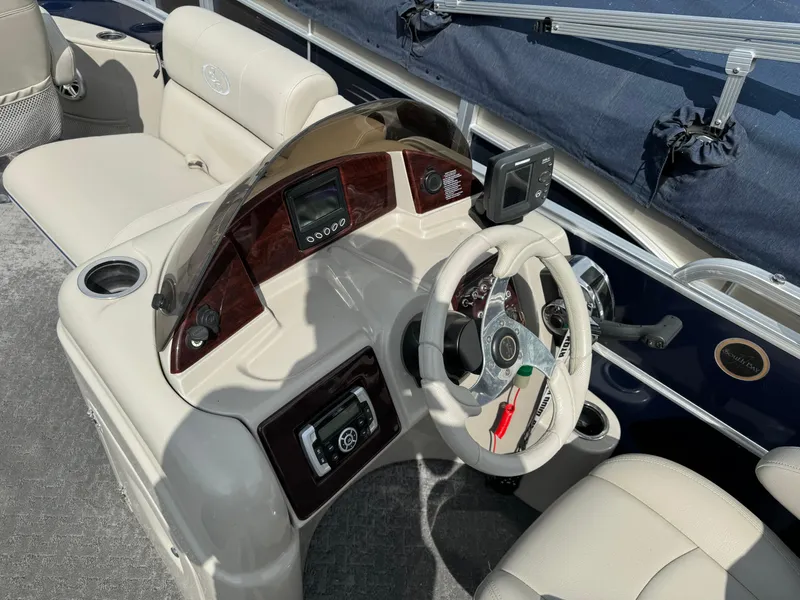 Slide: The Image of 2014 South Bay 520FC boat helm with steering wheel and control panel. - 16