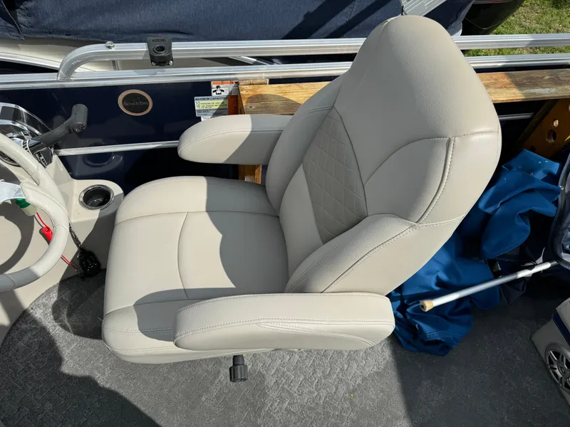 Slide: The Image of 2014 South Bay 520FC boat captain's chair with beige upholstery and armrests. - 18