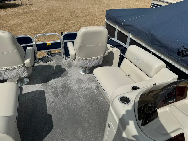 Slide: The Image of 2014 South Bay 520FC pontoon boat interior with beige seating and steering console. - 20