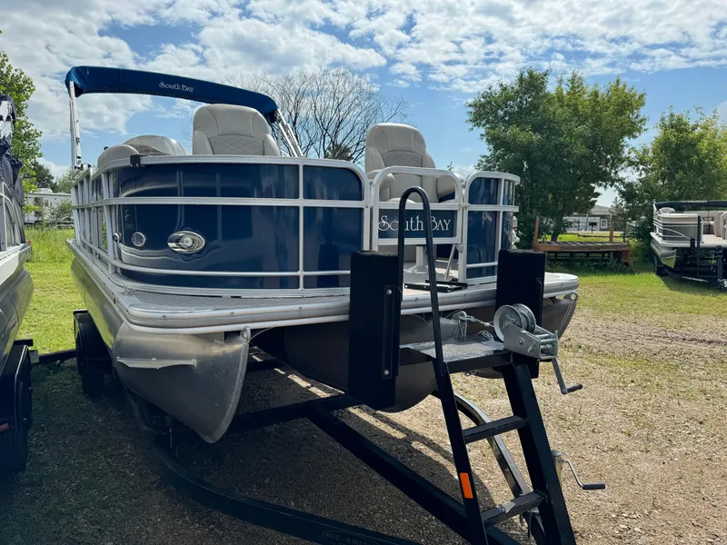 Slide: The Image of 2014 South Bay 520FC pontoon boat on a trailer, parked outdoors. - 4