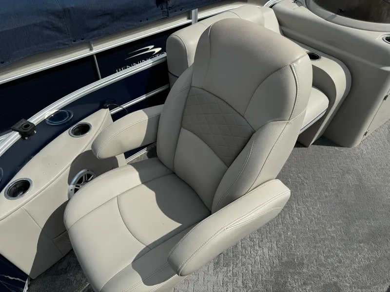 Slide: The Image of 2014 South Bay 520FC boat with beige captain's chair and cup holders. - 7