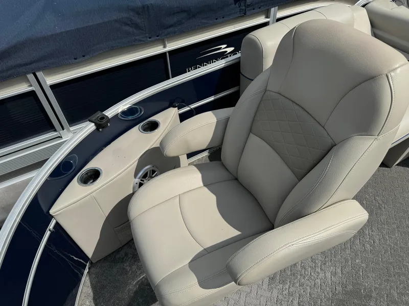 Slide: The Image of 2014 South Bay 520FC boat with beige captain's chair and cup holders. - 8