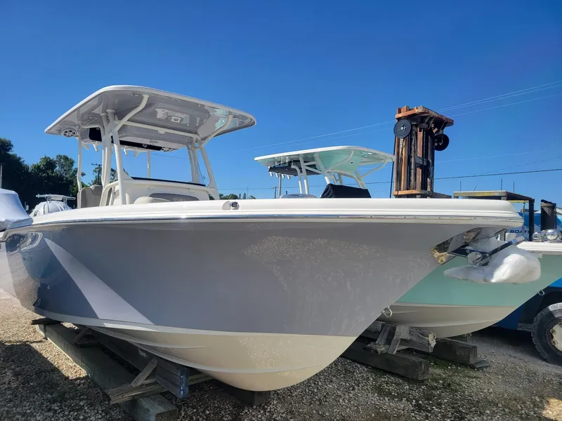 The Image of 2024 Key West 263 FS boat on trailer, parked outdoors under a clear sky. - 0