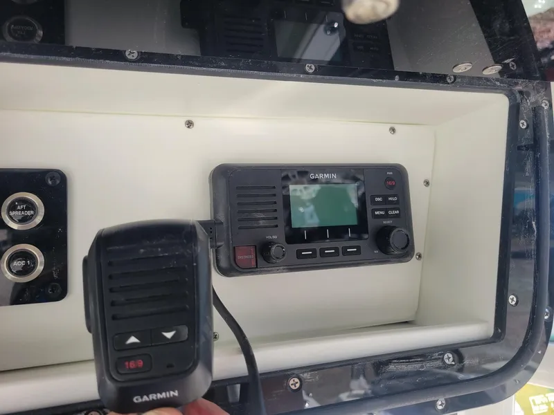 Slide: The Image of 2024 Key West 263 FS boat interior with seating, storage, and fishing rod holders. - 12