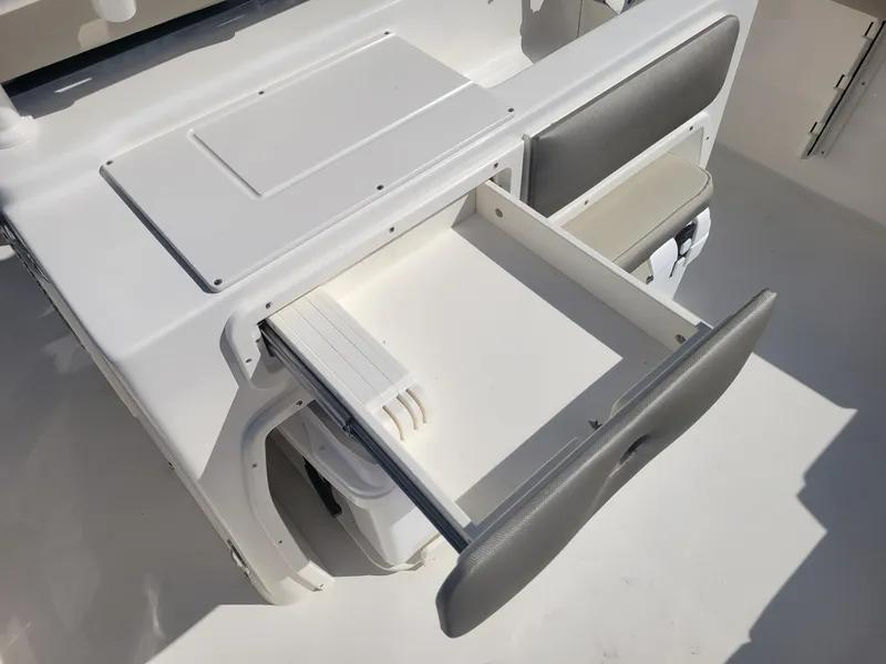 Slide: The Image of 2024 Key West 263 FS boat interior with cushioned seating and cup holders. - 18