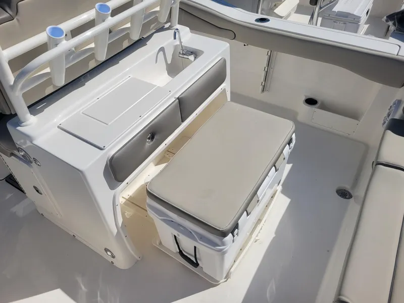 Slide: The Image of 2024 Key West 263 FS boat interior with cushioned seating and cup holders. - 19