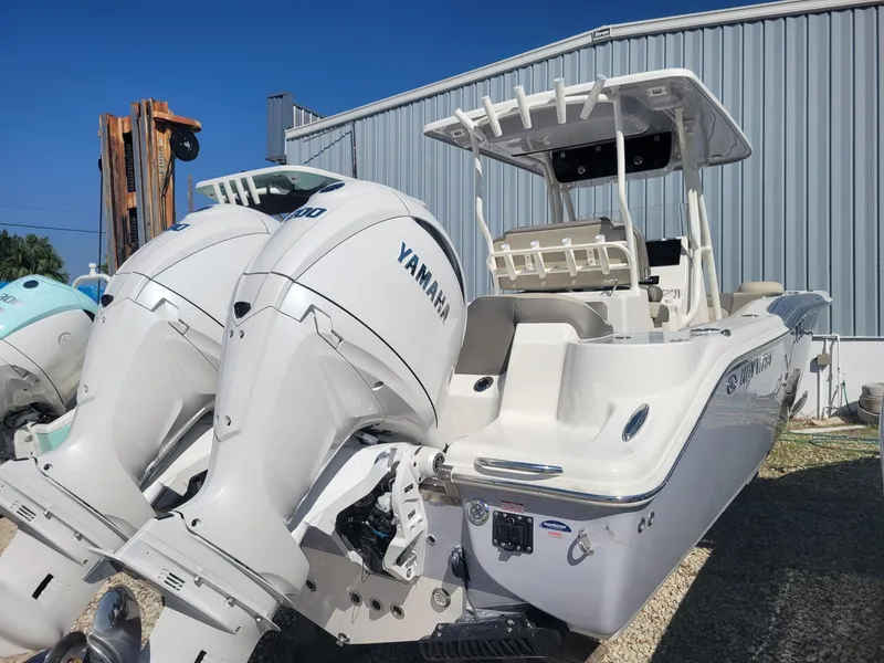 Slide: The Image of 2024 Key West 263 FS boat with dual Yamaha engines on a trailer in a dealership lot. - 3