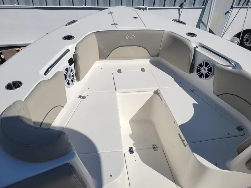 Slide: The Image of 2024 Key West 263 FS boat interior with cushioned seating and Yamaha engines. - 8