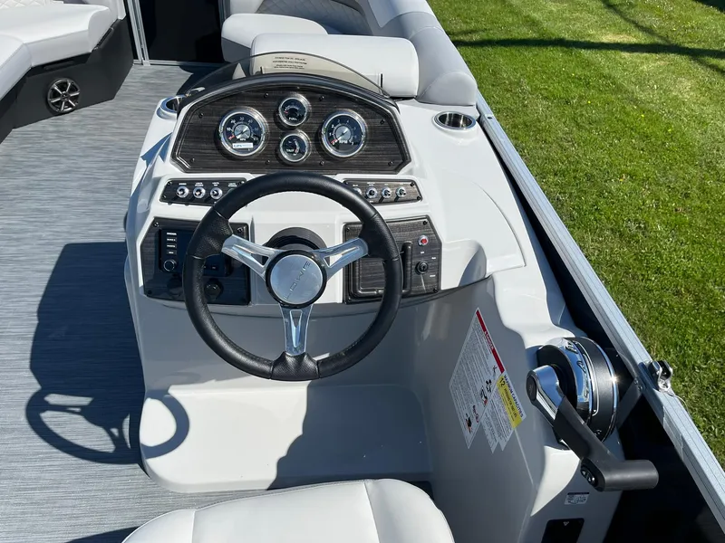 Slide: The Image of 2024 Lowe SS 210 WT boat dashboard with steering wheel and control panel. - 14