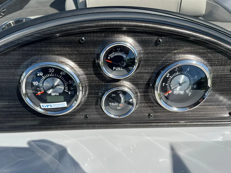 Slide: The Image of Dashboard of 2024 Lowe SS 210 WT boat with speedometer, fuel gauge, trim, and RPM dials. - 23