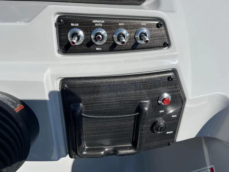 Slide: The Image of Control panel of 2024 Lowe SS 210 WT boat with switches and ignition. - 24