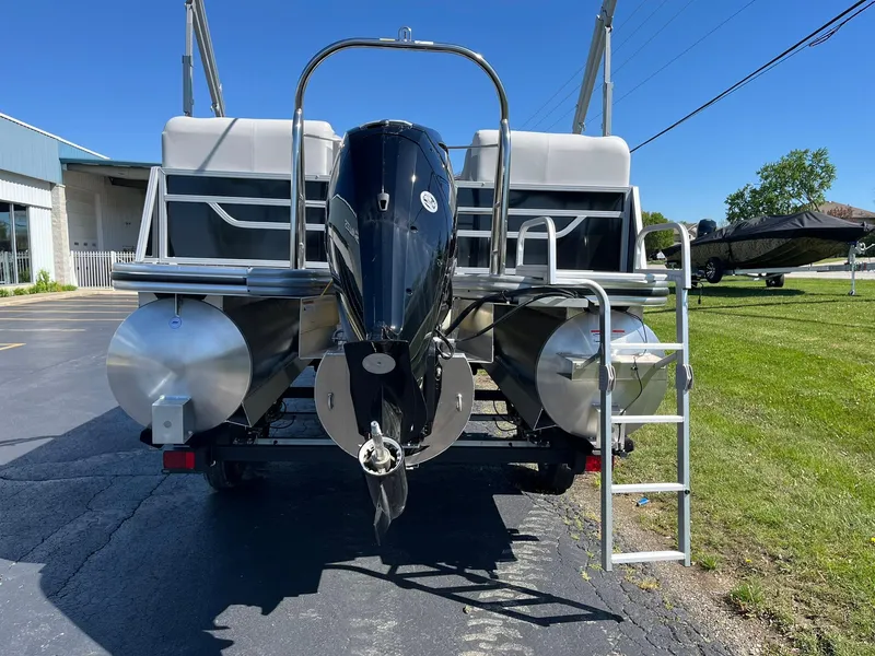 Slide: The Image of 2024 Lowe SS 210 WT pontoon boat rear view with outboard motor and ladder. - 3