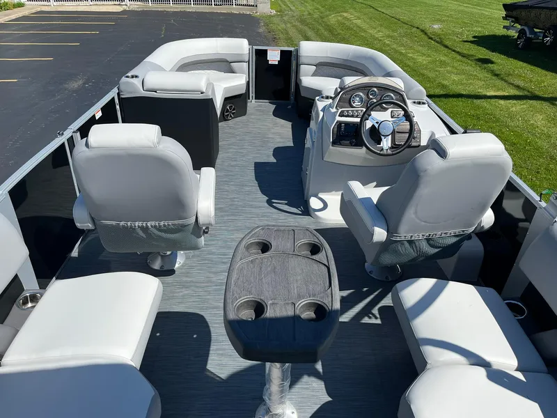 Slide: The Image of 2024 Lowe SS 210 WT pontoon boat interior with gray seating and steering console. - 7