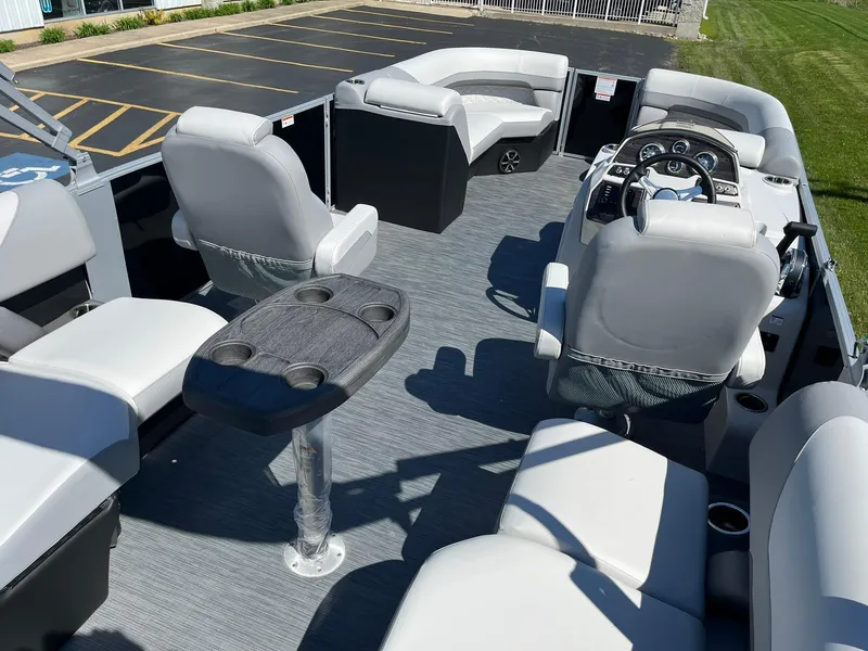 Slide: The Image of 2024 Lowe SS 210 WT pontoon boat interior with seating and steering console. - 8