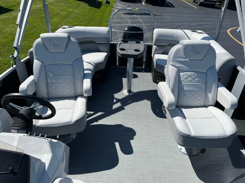 Slide: The Image of 2024 Lowe SS 210 WT boat interior with plush seating and modern steering console. - 9