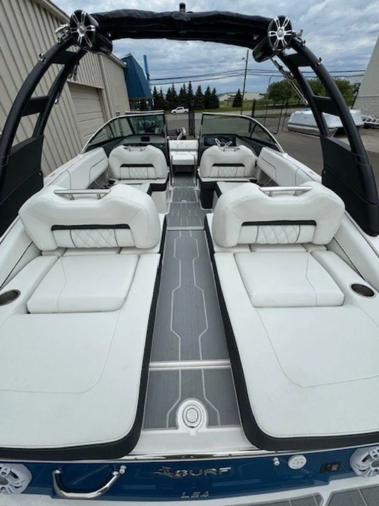 Slide: The Image of 2024 Regal LS4 Surf boat interior with luxurious white seating and sleek design. - 4