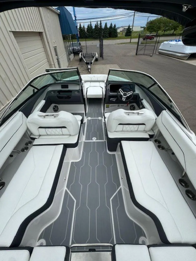 Slide: The Image of 2024 Regal LS4 Surf boat interior with sleek white seating and modern design. - 5