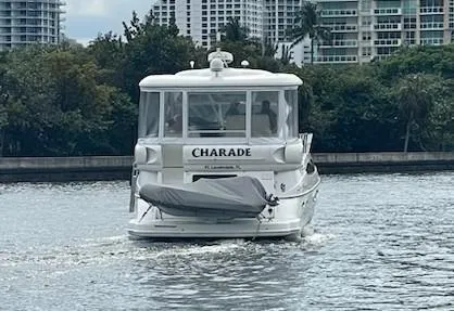 Slide: The Image of 2004 Cruisers Yachts 455 Express Motoryacht on water, rear view with cityscape background. - 24