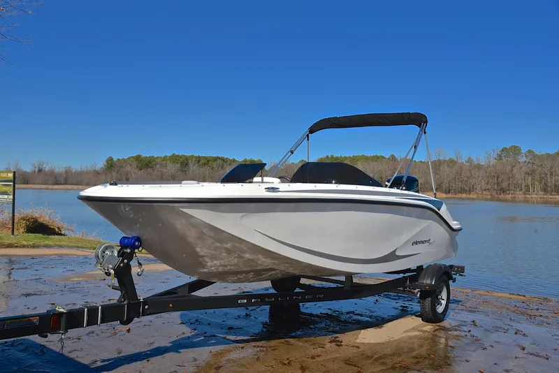Slide: The Image of 2023 Bayliner Element M17 boat on trailer by a lake. - 10