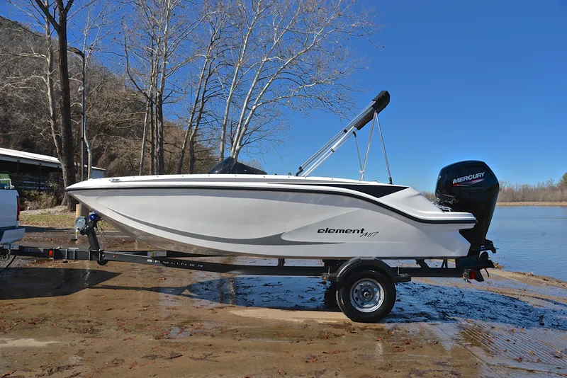 Slide: The Image of 2023 Bayliner Element M17 boat on trailer by a lake. - 11