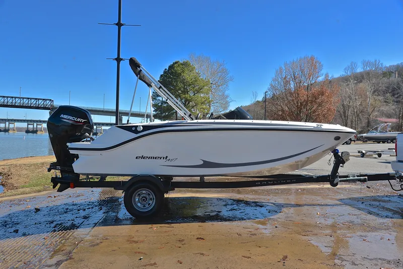 Slide: The Image of 2023 Bayliner Element M17 boat on trailer by the water. - 15