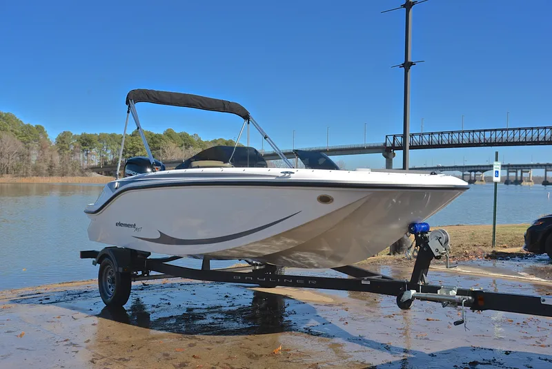 Slide: The Image of 2023 Bayliner Element M17 boat on a trailer by a lake. - 16