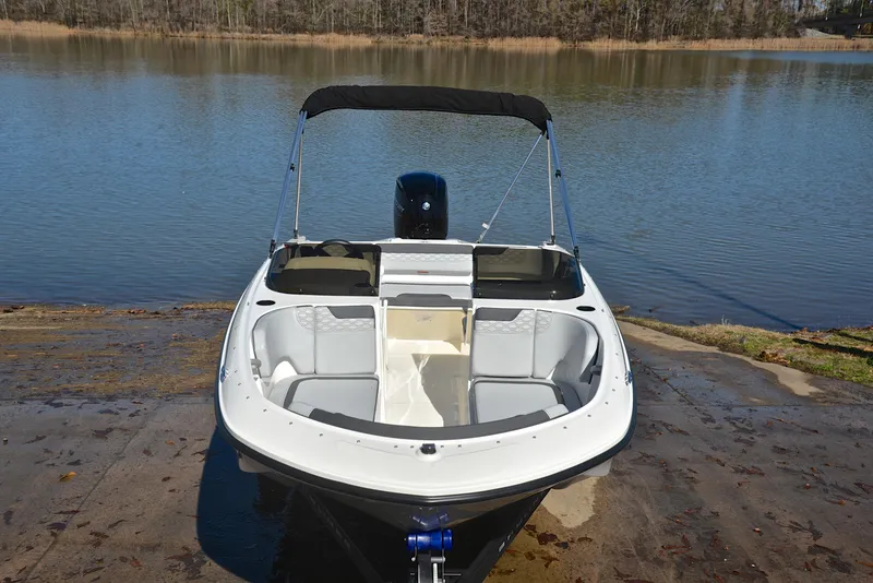 Slide: The Image of 2023 Bayliner Element M17 boat at a lakeside dock. - 17