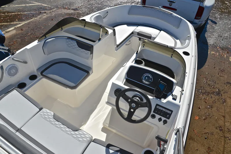 Slide: The Image of 2023 Bayliner Element M17 boat interior with steering wheel and seating. - 19