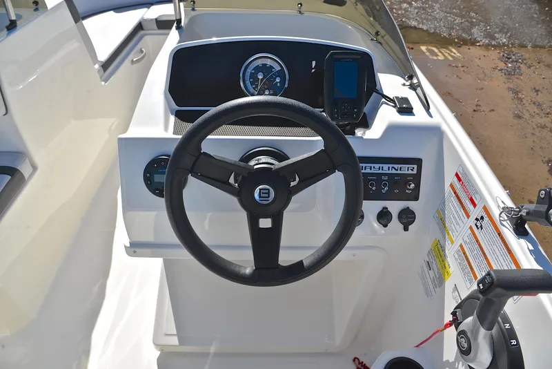 Slide: The Image of 2023 Bayliner Element M17 boat dashboard with steering wheel and control panel. - 23