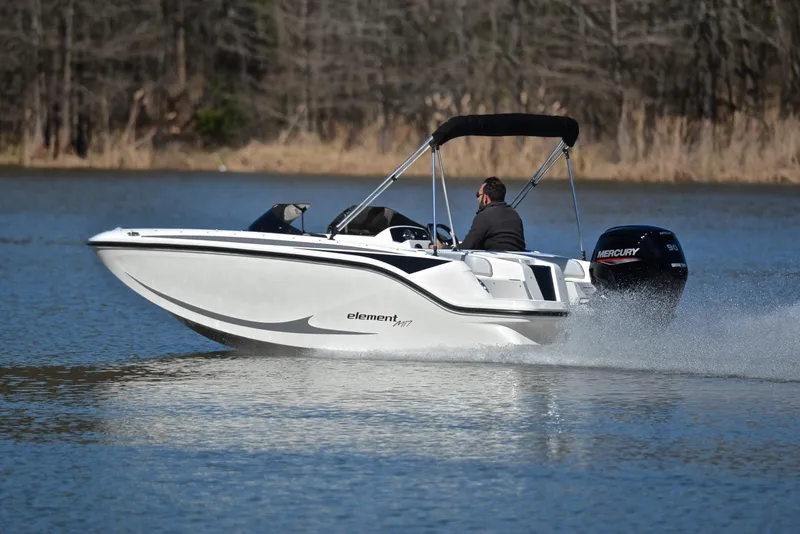 Slide: The Image of 2023 Bayliner Element M17 boat cruising on a lake. - 4