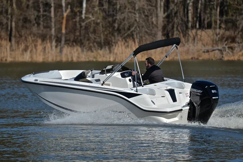 Slide: The Image of 2023 Bayliner Element M17 boat cruising on a lake with a Mercury 90 outboard motor. - 6