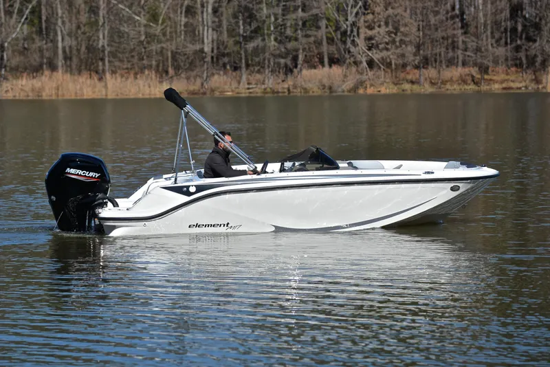 Slide: The Image of 2023 Bayliner Element M17 boat cruising on a calm lake. - 7