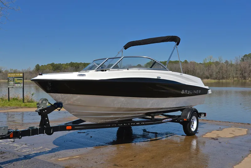 Slide: The Image of 2013 Bayliner 185 boat on trailer by a lake. - 10