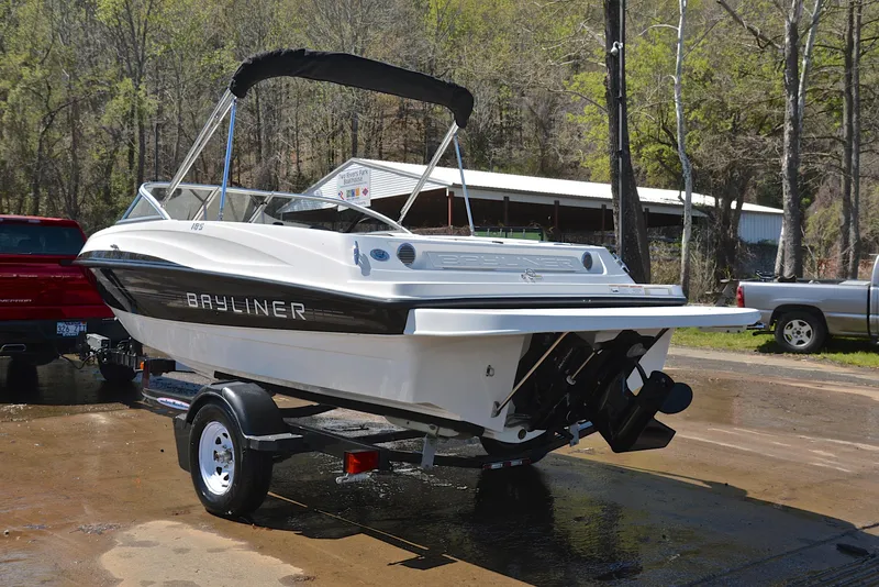 Slide: The Image of 2013 Bayliner 185 boat on a trailer, parked outdoors. - 12