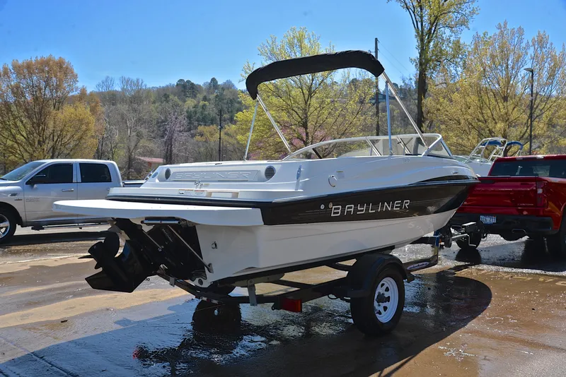 Slide: The Image of 2013 Bayliner 185 boat on a trailer in a parking lot. - 14