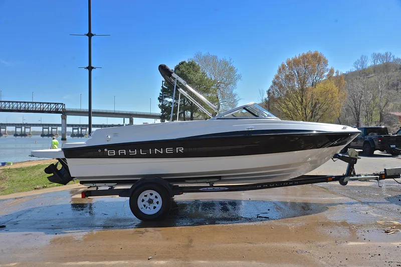 Slide: The Image of 2013 Bayliner 185 boat on trailer near a river. - 15