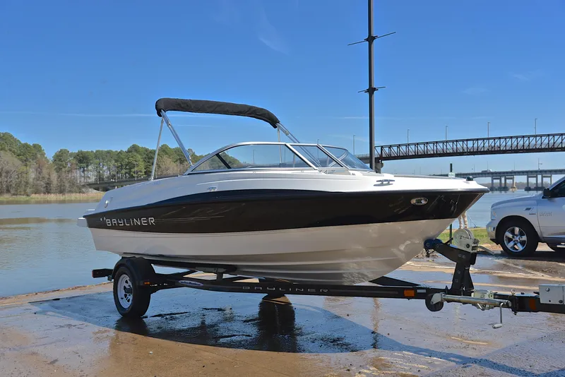 Slide: The Image of 2013 Bayliner 185 boat on trailer by the water. - 16