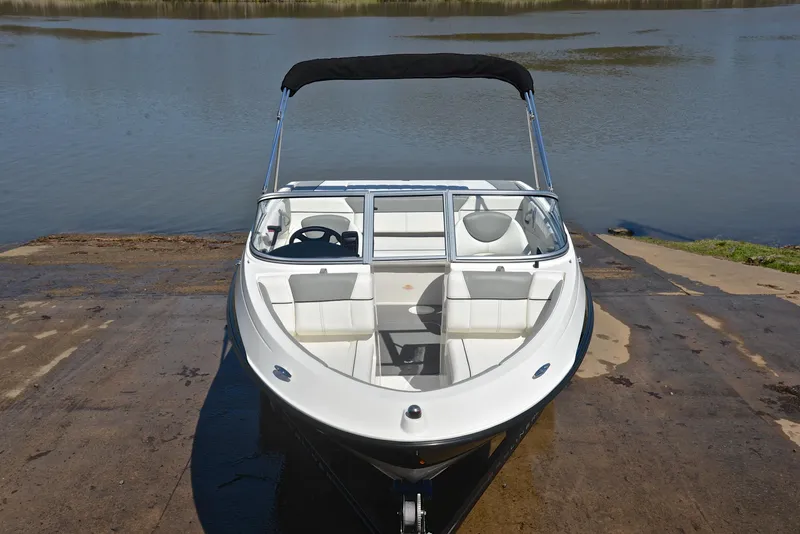 Slide: The Image of 2013 Bayliner 185 boat on a boat ramp by the water. - 17