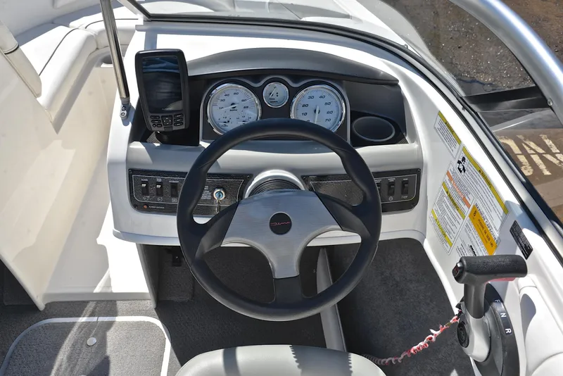Slide: The Image of 2013 Bayliner 185 boat dashboard with steering wheel and instrument panel. - 24