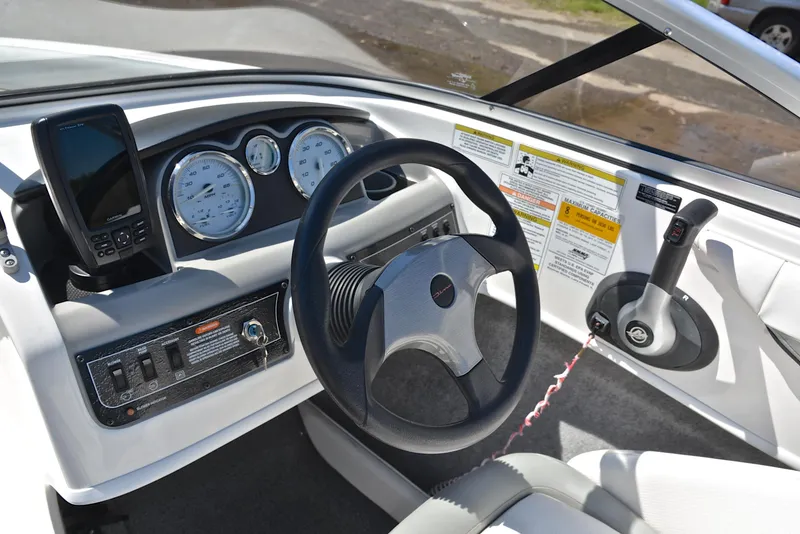 Slide: The Image of 2013 Bayliner 185 boat dashboard with steering wheel and control panel. - 25